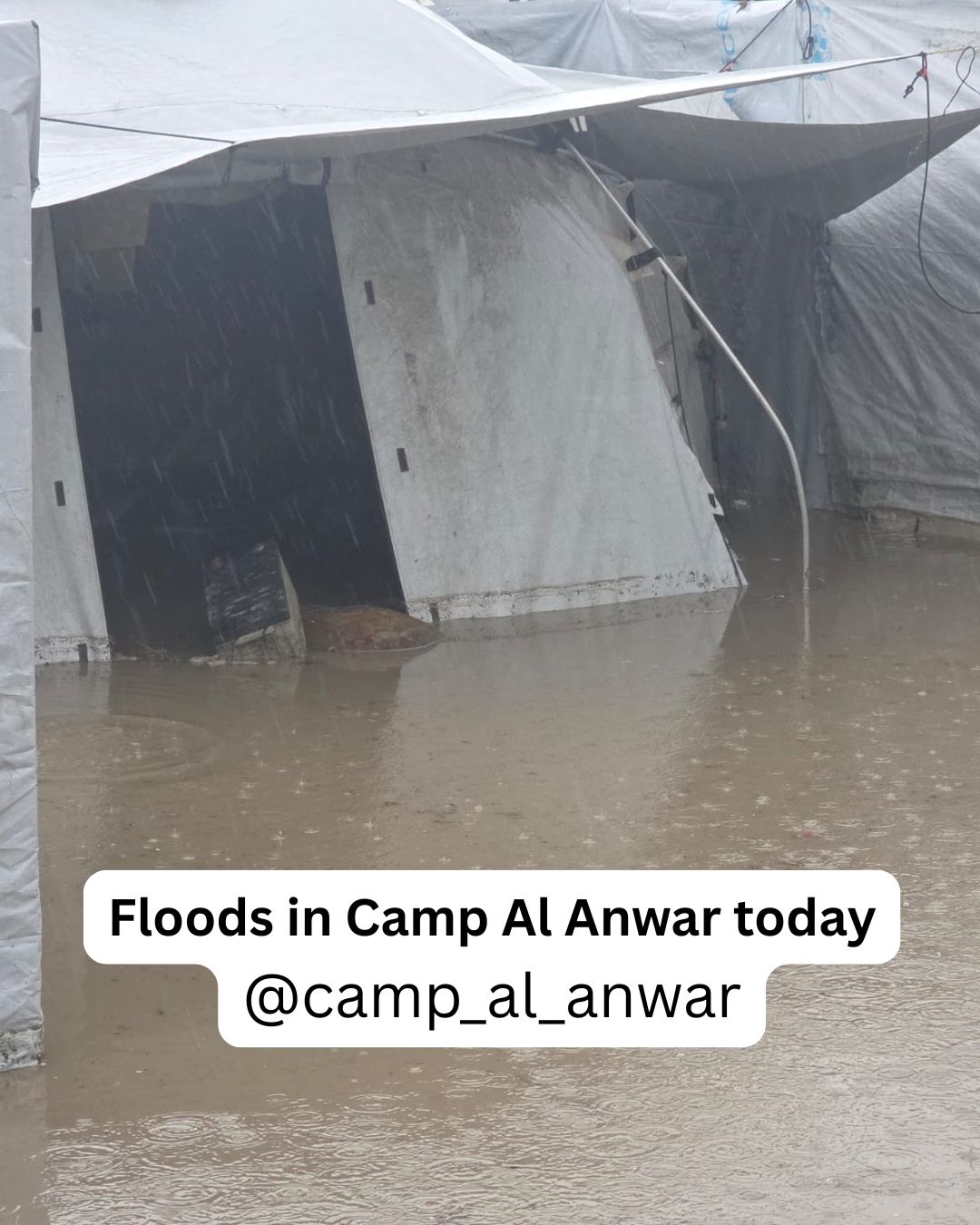 Standing floodwater surrounding tents at Al Anwar, with the original archive caption embedded in the photograph